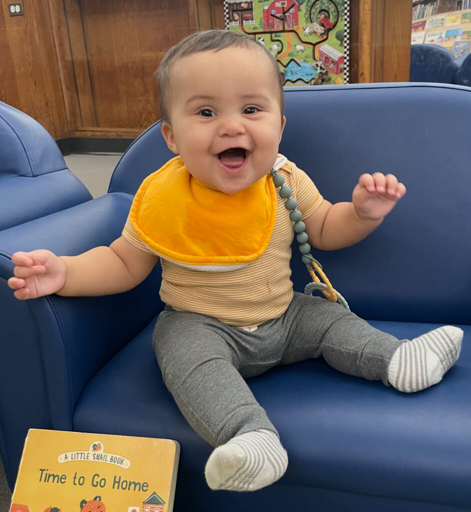 baby sitting up and smiling